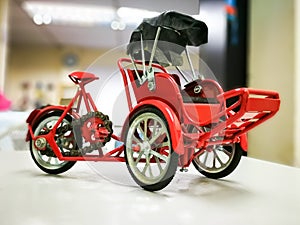 Beautiful red trishaw model on the table