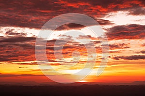 Beautiful red vibrant burning sunset sky with clouds