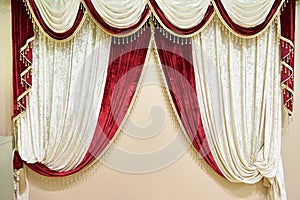 Beautiful red white velvet curtain on beige wall