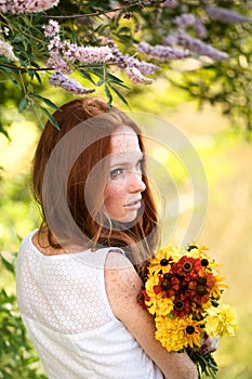 Beautiful redhair bride outdoors in park