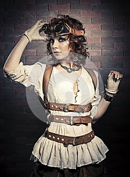 Beautiful redhair woman with steampunk goggles