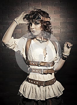 Beautiful redhair woman with steampunk goggles . Old-fashioned. photo