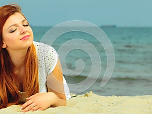 Beautiful redhaired girl on beach, portrait