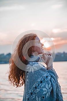 Beautiful red-haired girl at sunset.