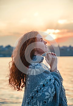 Beautiful redhaired girl at sunset.