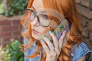 Beautiful redhead Caucasian girl talking on smart phone