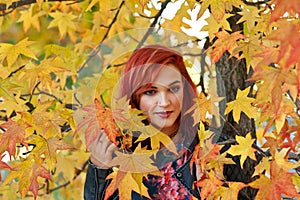 Beautiful redhead girl in autumn scene