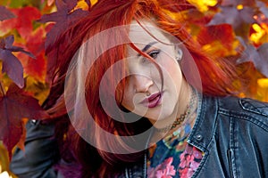Beautiful redhead girl in autumn scene