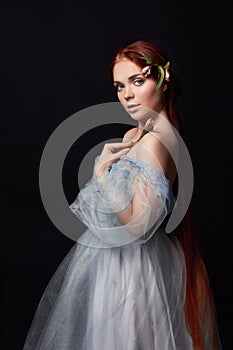 beautiful redhead girl with long hair in dress cotton retro. Woman portrait on black background. Deep eyes. Natural beauty