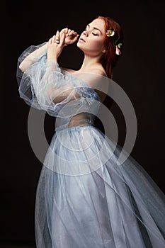 beautiful redhead girl with long hair in dress cotton retro. Woman portrait on black background. Deep eyes. Natural beauty