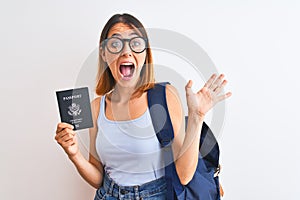 Beautiful redhead student woman wearing backpack and holding passport of united states very happy and excited, winner expression