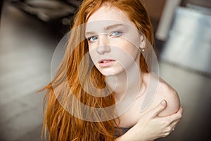 Beautiful redhead woman looking at camera photo