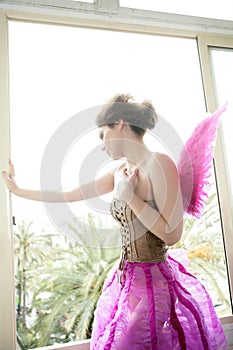 Beautiful redhead woman with pink wings