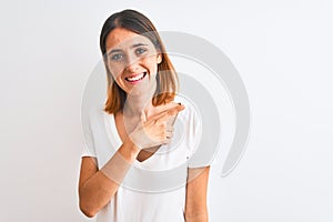 Beautiful redhead woman wearing casual white t-shirt over isolated background cheerful with a smile of face pointing with hand and