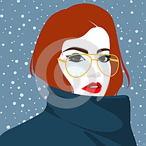 Beautiful redhead woman wearing the golden glasses and dark blue coat against winter snowing background