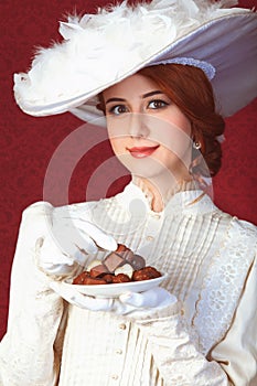 Beautiful redhead women with candy.