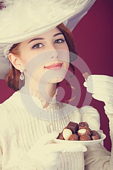 Beautiful redhead women with candy.