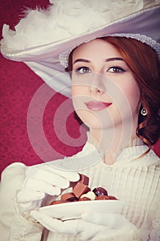 Beautiful redhead women with candy.