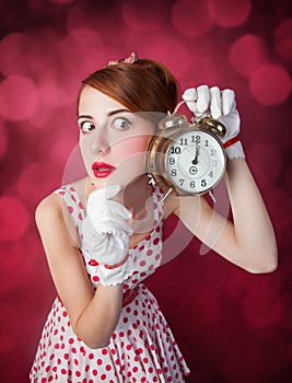 Beautiful redhead women with clock.