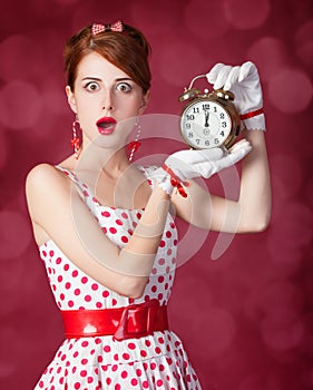 Beautiful redhead women with clock.