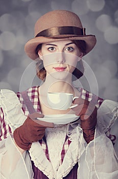 Beautiful redhead women with cup of tea.