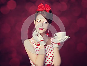 Beautiful redhead women with cup of tea.