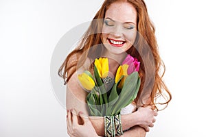 Beautiful redheaded girl with bouquet of tulips