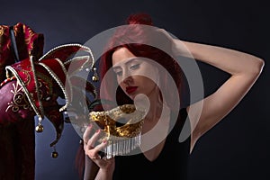 Beautiful redheaded woman with carnival mask