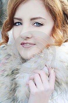 Beautiful redheaded woman in fur coat