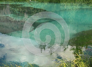 Beautiful reflection of trees and clouds in a lake