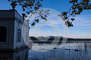 Beautiful reflections at the Banyoles lake at sunset. Calm lake water at dusE at Wstany de Banyoles. Concept of peaceful and