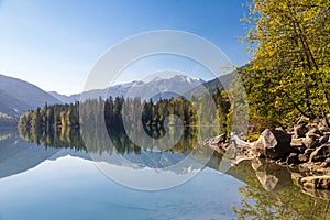 Beautiful reflections of forested Birkenhead lake shoreline and mountains