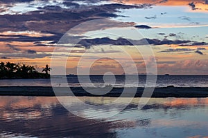 Beautiful reflections on the ocean of sunset in Fiji photo
