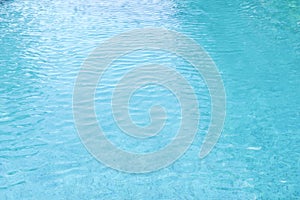 Beautiful refreshing blue swimming pool water. Close up, selective focus. Blue background