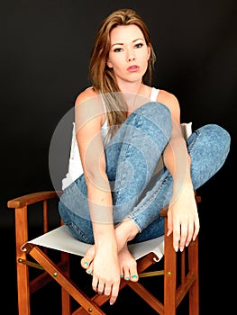 Beautiful Relaxed Anxious Thoughtful Young Woman Sitting in a Chair