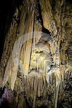 A beautiful Resava cave (Resavska pecina) in Serbia, massive columns of stalagmites and stalactites on the cave bottom.