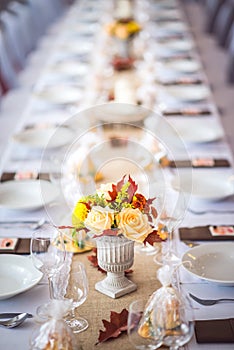 Beautiful restaurant interior table decoration for wedding or event. Flower Wedding Table Decoration/ Autumn colors.