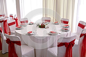 A beautiful restaurant table decorated with red ribbons, Chinese New Year, table number six, in anticipation of a banquet