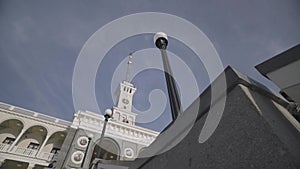 Beautiful restored building and a street lamp on blue sky background. Action. Bottom view of an antique church and a