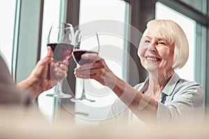 Beautiful retired lady drinking wine with a man