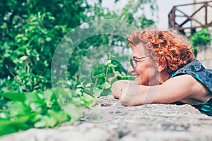 Beautiful retro older woman in front of the brick wall