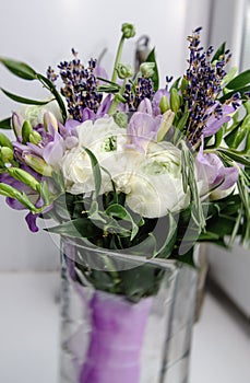 Beautiful rich bunch of purple fresia, buttercup ranunculus peony, green leaf, lilac lavender, roses, rosemary bouquet