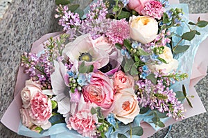 Beautiful wedding pink bouquet, flowers arrangement by florist with roses, lilac and blue flowers. Floral background