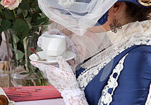 Beautiful rich women with cup of tea in retro style