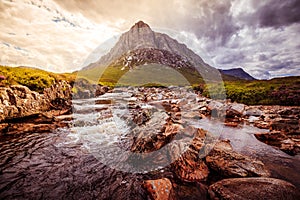 Beautiful river mountain landscape scenery in Glen Coe, Scottish Highlands, Scotland. Sunshine