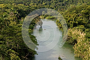 Beautiful river passing through lush green trees in La Arboleda protected area, Matanzas, Cuba photo