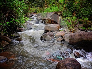 Beautiful river stream running through rocks in asian rain forest full hd
