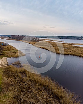 Beautiful riverside areal view of river Lielupe flowing near pine forest strees on both coast lines