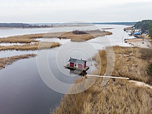 Beautiful riverside areal view of river Lielupe flowing near pine forest strees on both coast lines