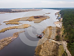 Beautiful riverside areal view of river Lielupe flowing near pine forest strees on both coast lines